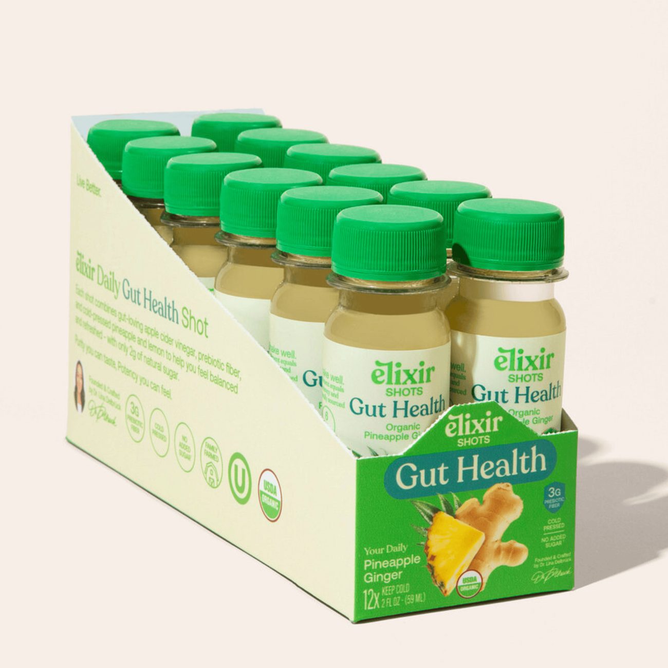 An open 12-pack case of Elixir Gut Health wellness shots
